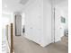 Upstairs hallway with white doors, carpet flooring, and wooden railing at 2097 Celebration Blvd, Celebration, FL 34747