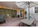 Paved patio with outdoor furniture, grill, and lush green wall at 2097 Celebration Blvd, Celebration, FL 34747