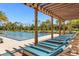 Community pool with pergola-covered lounge chairs at 2097 Celebration Blvd, Celebration, FL 34747
