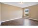 Empty bedroom with wood-look laminate flooring and window at 2410 Hatton Chase Ln, Kissimmee, FL 34746