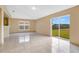 Living room with tile floors, sliding glass door, and neutral colored walls at 2410 Hatton Chase Ln, Kissimmee, FL 34746