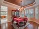 Formal dining room with a chandelier, wooden hutch, and windows with shutters at 25629 Hawks Run Ln, Sorrento, FL 32776