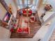 Aerial view of the living room with brown leather furniture, a fireplace, and wood floors at 25629 Hawks Run Ln, Sorrento, FL 32776