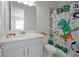 bathroom with white vanity, granite countertop, and fun shower curtain at 3359 Hanging Tide St, Winter Garden, FL 34787