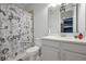 Bathroom with a game-themed shower curtain and white vanity at 3359 Hanging Tide St, Winter Garden, FL 34787