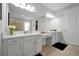Elegant bathroom boasts double vanity and large mirror at 3359 Hanging Tide St, Winter Garden, FL 34787