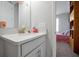 Simple bathroom with single vanity and view of bedroom at 3359 Hanging Tide St, Winter Garden, FL 34787