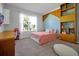 Charming bedroom with a pink theme and built in shelves at 3359 Hanging Tide St, Winter Garden, FL 34787