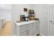 Built-in coffee bar with white cabinets and quartz countertop at 3359 Hanging Tide St, Winter Garden, FL 34787