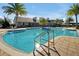 Sparkling community pool with lounge chairs and palm trees at 3359 Hanging Tide St, Winter Garden, FL 34787