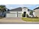 Two-story house with gray siding, two-car garage, and landscaped front yard at 3359 Hanging Tide St, Winter Garden, FL 34787
