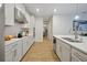 Modern kitchen with white cabinets, a large island, and tile flooring at 3359 Hanging Tide St, Winter Garden, FL 34787