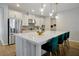 Modern kitchen with white cabinets, quartz countertops, and stainless steel appliances at 3359 Hanging Tide St, Winter Garden, FL 34787