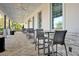 Covered patio with tables and chairs for outdoor dining at 3359 Hanging Tide St, Winter Garden, FL 34787