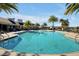 Resort-style pool with lounge chairs and palm trees at 3359 Hanging Tide St, Winter Garden, FL 34787