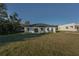 Single-story home with a grassy backyard and neutral siding at 4160 Sw 133Rd Ln, Ocala, FL 34473