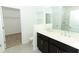 Double vanity bathroom with dark brown cabinets at 5021 Bougainvillea Ct, Lake Hamilton, FL 33851