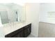 Double vanity bathroom with dark brown cabinets at 5021 Bougainvillea Ct, Lake Hamilton, FL 33851