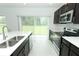 Modern kitchen with stainless steel appliances and white countertops at 5021 Bougainvillea Ct, Lake Hamilton, FL 33851