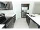 Modern kitchen with dark cabinets, stainless steel appliances, and an island at 5021 Bougainvillea Ct, Lake Hamilton, FL 33851