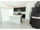 Modern kitchen with dark cabinets, stainless steel appliances, and an island at 5021 Bougainvillea Ct, Lake Hamilton, FL 33851