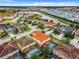 Aerial view of neighborhood with lake and houses at 5303 Wildwood Way, Davenport, FL 33837