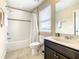 Clean bathroom with tub, shower, and dark vanity at 5303 Wildwood Way, Davenport, FL 33837