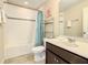 Clean bathroom with tub, shower, and dark vanity at 5303 Wildwood Way, Davenport, FL 33837