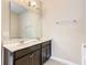 Double vanity bathroom with dark wood cabinets at 5303 Wildwood Way, Davenport, FL 33837