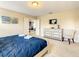 Main bedroom with blue bedding, large dresser and access to other rooms at 5303 Wildwood Way, Davenport, FL 33837