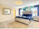 Bright bedroom with a plush bed, accent wall and plenty of light at 5303 Wildwood Way, Davenport, FL 33837
