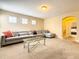 Spacious bonus room with L-shaped sectional sofa and glass coffee table at 5303 Wildwood Way, Davenport, FL 33837