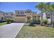 Two-story home with a two-car garage and palm trees in the front yard at 5303 Wildwood Way, Davenport, FL 33837