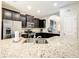 Modern kitchen featuring granite countertops, stainless steel appliances, and a breakfast bar at 5303 Wildwood Way, Davenport, FL 33837