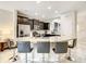 Kitchen with granite island, seating for four, and dark wood cabinets at 5303 Wildwood Way, Davenport, FL 33837