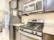 Modern kitchen featuring stainless steel appliances and granite countertops at 5303 Wildwood Way, Davenport, FL 33837
