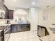 Spacious kitchen with dark cabinetry, granite countertops, and stainless steel appliances at 5303 Wildwood Way, Davenport, FL 33837