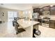 Open kitchen with granite island, stainless steel appliances, and breakfast bar at 5303 Wildwood Way, Davenport, FL 33837