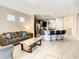 Open living space with kitchen views, comfortable seating, and large windows at 5303 Wildwood Way, Davenport, FL 33837