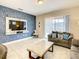 Comfortable living room with a sofa, coffee table, and large TV at 5303 Wildwood Way, Davenport, FL 33837