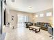 Living area featuring a gray sofa, coffee table, and sliding glass doors to patio at 5303 Wildwood Way, Davenport, FL 33837