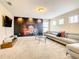 Home theater with large sectional sofa and movie-themed wall mural at 5303 Wildwood Way, Davenport, FL 33837