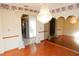 Elegant dining room with hardwood floors, chandelier, and mirrored walls at 536 Fourwind St, Deltona, FL 32725