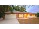 Brick home with a white garage door at dusk at 536 Fourwind St, Deltona, FL 32725