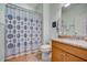 Bathroom with patterned shower curtain, granite vanity, and toilet at 541 Cantabria Dr, Davenport, FL 33837