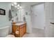 Small bathroom with granite countertop vanity and access to hallway at 541 Cantabria Dr, Davenport, FL 33837