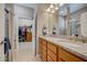 Double vanity bathroom with granite countertops and access to a walk-in closet at 541 Cantabria Dr, Davenport, FL 33837