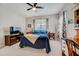 Comfortable bedroom with a double bed, built-in desk, and ceiling fan at 541 Cantabria Dr, Davenport, FL 33837