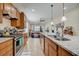 Open kitchen with large island, granite counters, and stainless steel appliances at 541 Cantabria Dr, Davenport, FL 33837