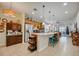 Modern kitchen boasts granite countertops, stainless steel appliances, and an island with seating at 541 Cantabria Dr, Davenport, FL 33837